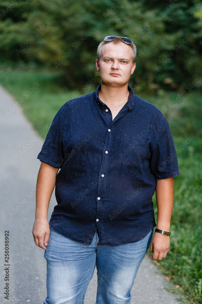 portrait of a fat guy in shorts in the park portrait of a fat guy in shorts in the park