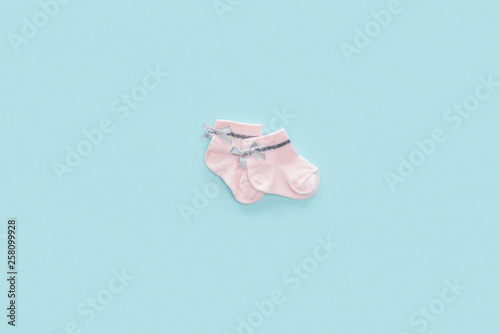 top view of pink socks on blue pastel background with copy space © LIGHTFIELD STUDIOS
