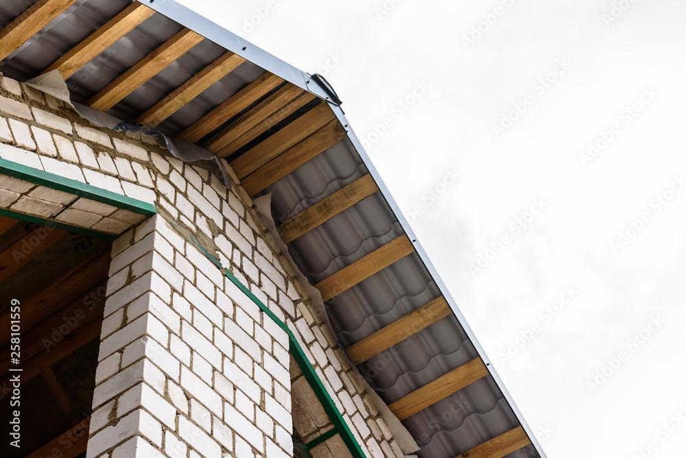 Construction of a pitched roof. Sheathing of metal roof. Roof slope. Construction of a pitched roof. Sheathing of metal roof. Roof slope.