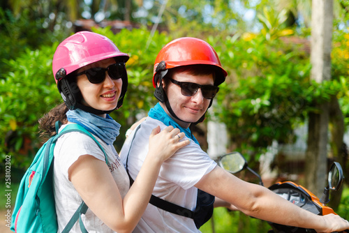 A man and a girl in helmets travel Asia Sri Lanka
