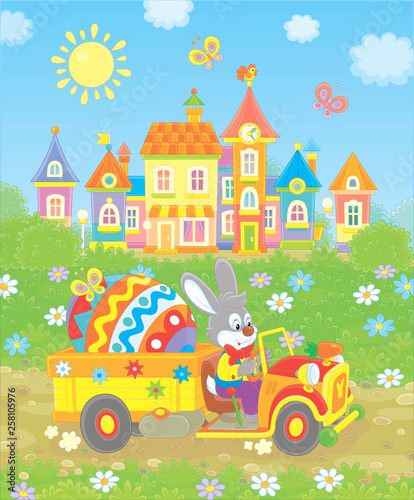 Grey rabbit driving a small toy truck with a big colored Easter egg, vector illustration in a cartoon style © Alexey Bannykh