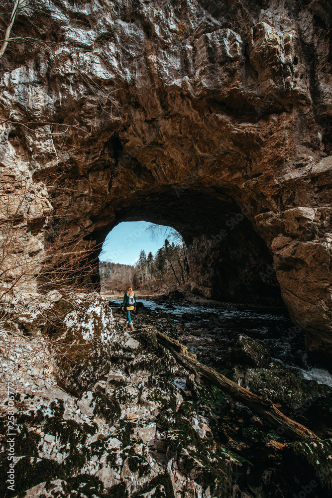 Woman explores the cave system Rakov Skocjan in Slovenia