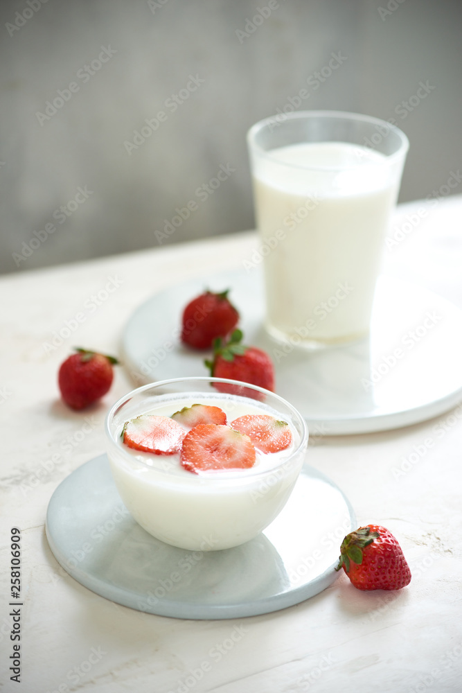 Fresh strawberry on a glass with dessert yogurt and strawberry on white background Fresh strawberry on a glass with dessert yogurt and strawberry on white background