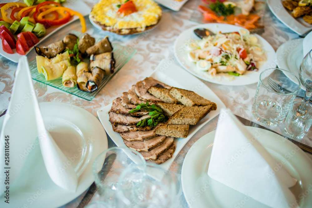 Buffet table of reception with cold snacks, meat and salads