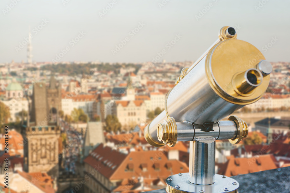 Binoculars on the viewpoint. Beautiful aerial view of the traditional old or medieval architecture in Prague in the Czech Republic is blurry ahead. Binoculars on the viewpoint. Beautiful aerial view of the traditional old or medieval architecture in Prague in the Czech Republic is blurry ahead.
