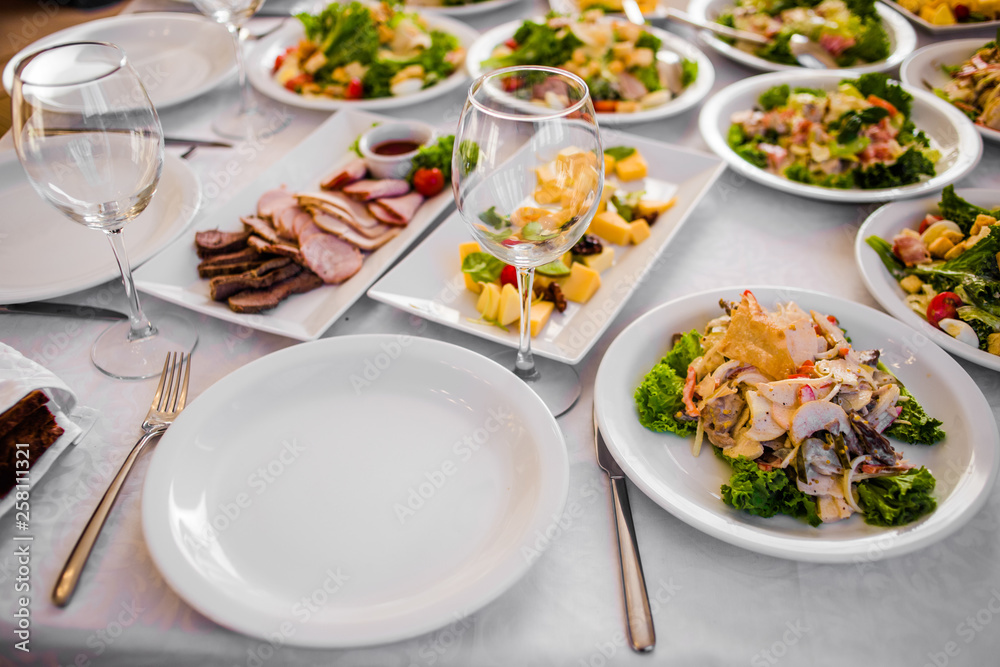 Buffet table of reception with cold snacks, meat and salads