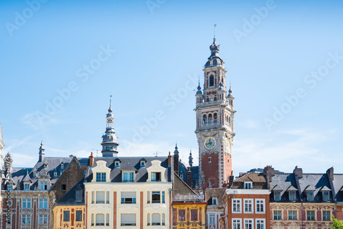tower of Chamber of commerce, buildings at central town square in Lille, France. Against blue sky. space for text