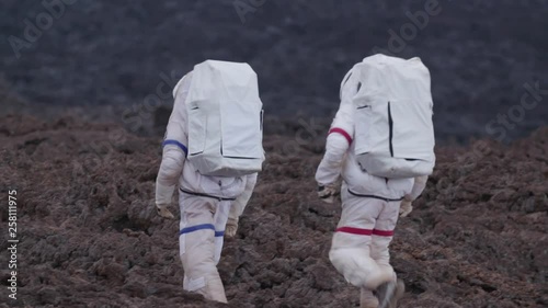 Two astronauts walking in a Martian landscape, Hawaii