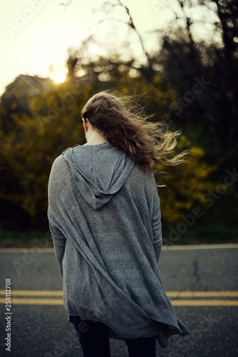 Young woman facing away with hair blowing in the wind 