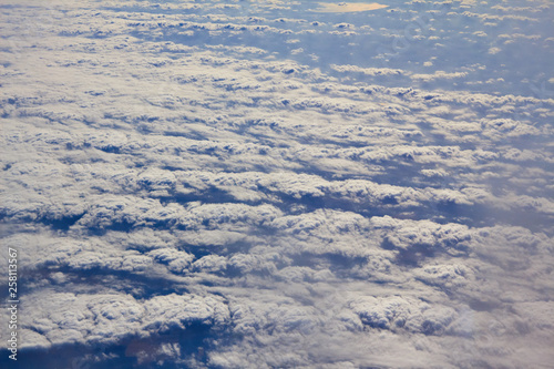 Photos of clouds from a height. Cloudy sky. Beautiful clouds in the blue sky. Clouds in clear weather. Sky texture The texture of the clouds. The texture of the earth. View of the ground from a height