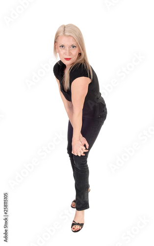 A happy looking blond woman standing in black outfit