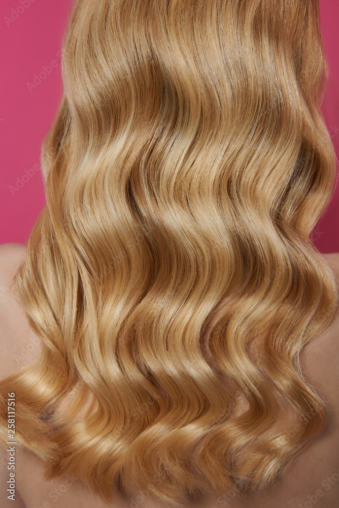 Fototapeta premium Close up beautiful blonde wavy hair of woman