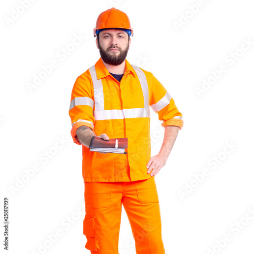 Man worker road constructor looking, notebook and pen in hand on white background isolation © Kabardins photo
