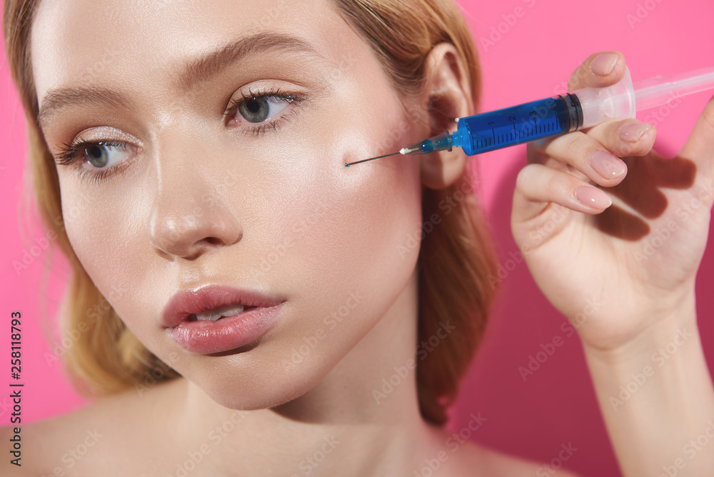 Filler injection on cheek-bone of young female Filler injection on cheek-bone of young female