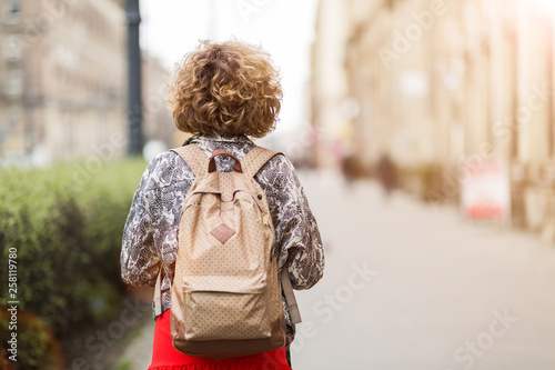 Young woman wearing backpack in city