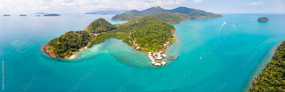Tropical landscape aerial panorama with island coastline and beaches surrounded by transparent blue sea water, green rainforest, panoramic view from drone, summer vacation holidays destination