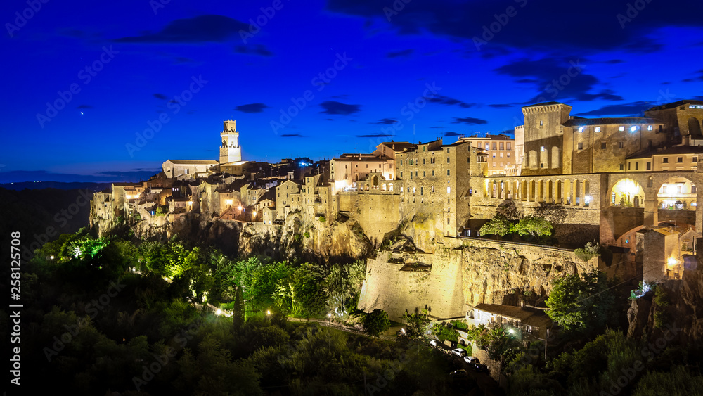 Panoramic view of an old town Pitigliano at the dusk, small old town in Maremma Region in Tuscany, Italy