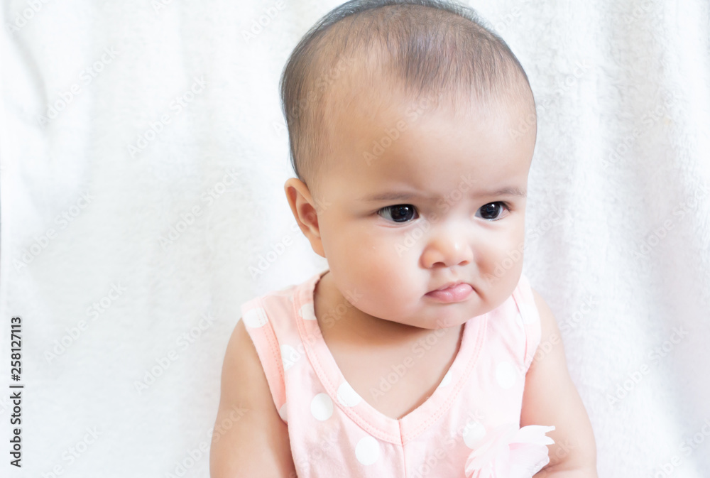 Asian baby girl wears pink shirt sitting on white background Asian baby girl wears pink shirt sitting on white background