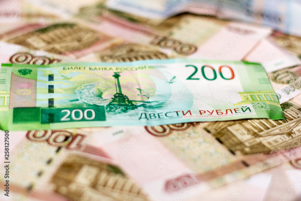 money background, Russian hundred-ruble and two-ruble bills in a mess lying on the table. money background, Russian hundred-ruble and two-ruble bills in a mess lying on the table.