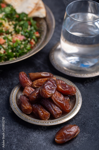Ramadan dates, water and tabbouleh is traditional food for iftar in islamic world