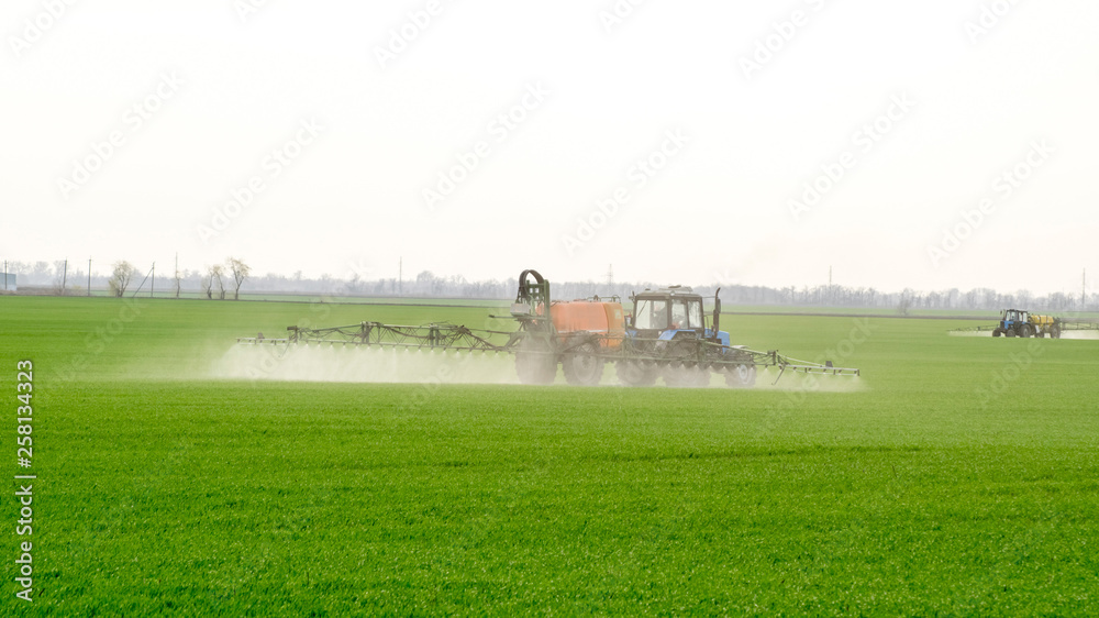 Tractor with a spray device for finely dispersed fertilizer. Tractor with a spray device for finely dispersed fertilizer.