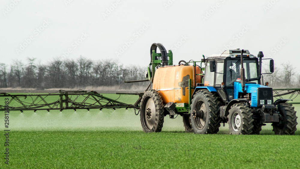 Obraz premium Tractor with a spray device for finely dispersed fertilizer.