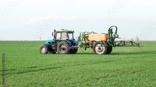 Tractor with a spray device for finely dispersed fertilizer.