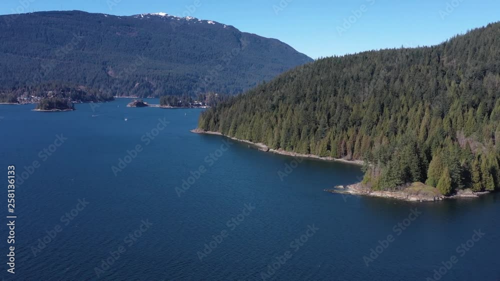Aerial view over Burrard Inlet, ocean and island with mountains in beautiful British Columbia. Canada. 4K. Aerial view over Burrard Inlet, ocean and island with mountains in beautiful British Columbia. Canada. 4K.
