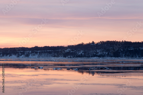 Late winter sunrise view of ice and rocks in the St. Lawrence river, Cap-Rouge area, Quebec City, Quebec, Canada