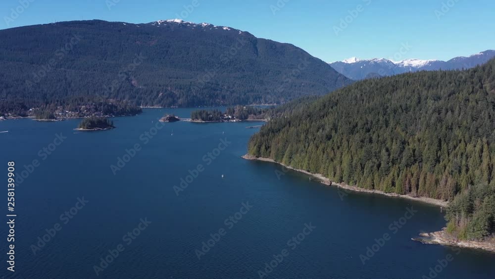 Aerial view over Burrard Inlet, ocean and island with mountains in beautiful British Columbia. Canada. 4K. Aerial view over Burrard Inlet, ocean and island with mountains in beautiful British Columbia. Canada. 4K.