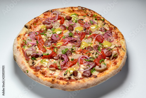 pizza with ham and tomatoes isolated on white