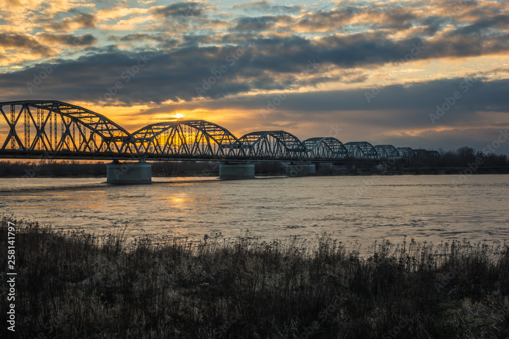 Sunset over the bridge over the Vistula river in Grudziadz, Kujawsko-Pomorskie, Poland Sunset over the bridge over the Vistula river in Grudziadz, Kujawsko-Pomorskie, Poland