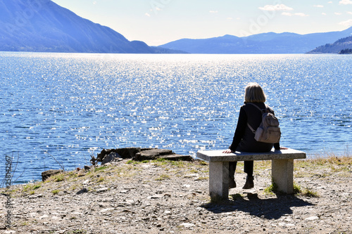 La donna intenta a osservare la tranquillità del lago Maggiore photo