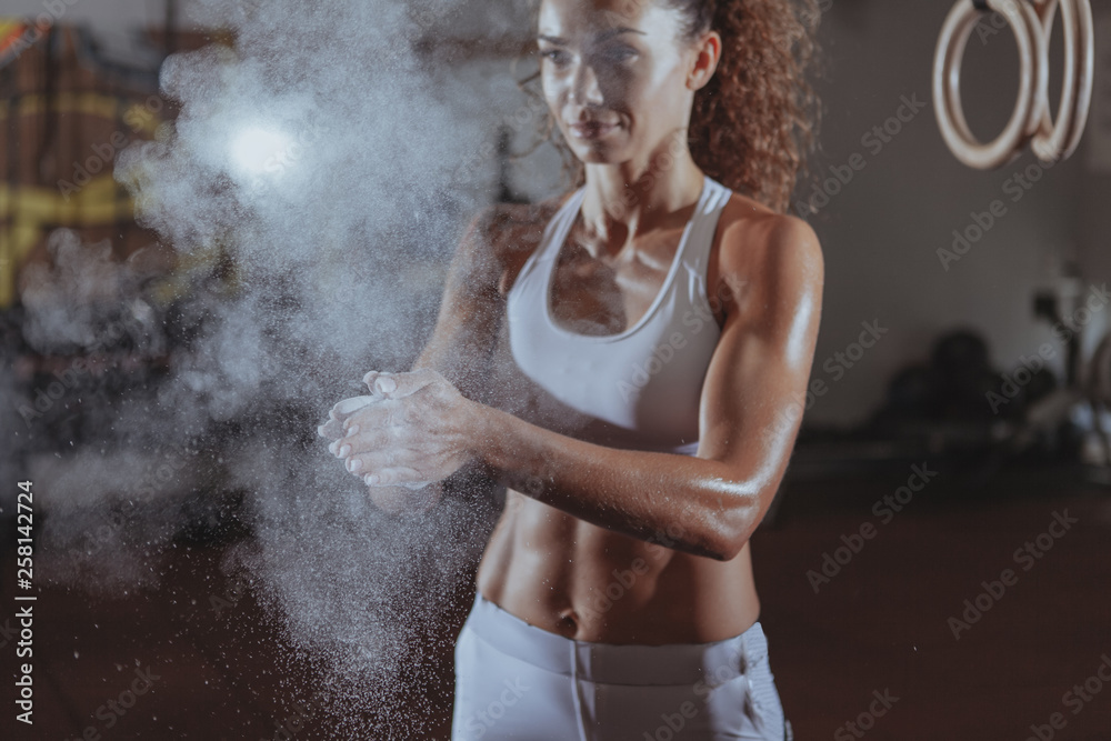 Clapping Body Cropped shot of a beautiful sportswoman with perfect abs and fit toned ...