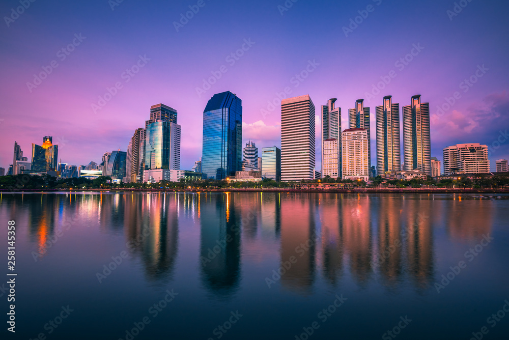 Panorama view of Benchakitti Park, Cityscape of skyscraper business reflection at Benchakitti park at twilight time in Bangkok, Thailand.