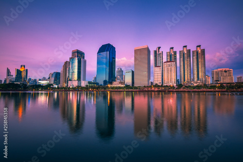 Panorama view of Benchakitti Park  Cityscape of skyscraper business reflection at Benchakitti park at twilight time in Bangkok  Thailand.