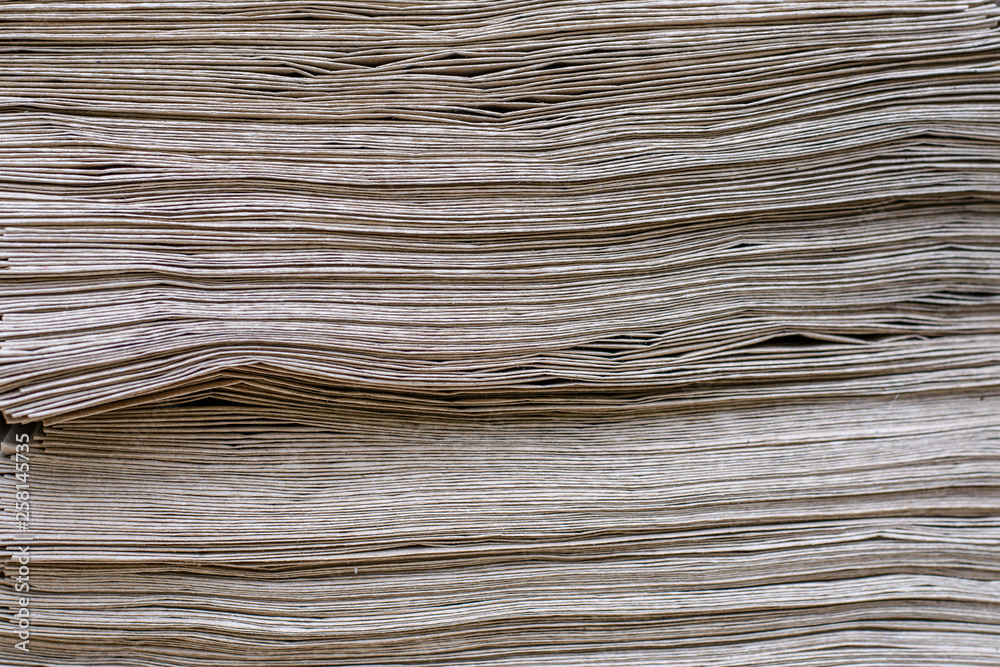 Fototapeta premium Side View Of Huge Stack of Recycled Paper close up. Business concept. Huge Stack of Recycled Paper envelopes closeup. Eco Kraft paper.