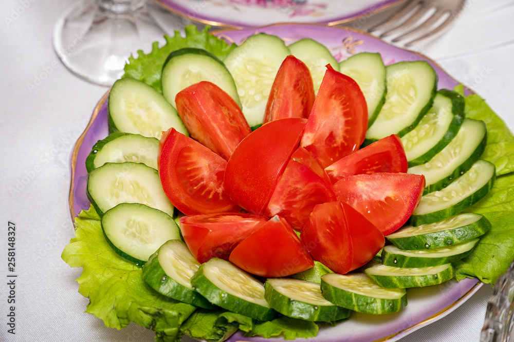 Sliced cucumbers and tomatoes in plate Sliced cucumbers and tomatoes in plate