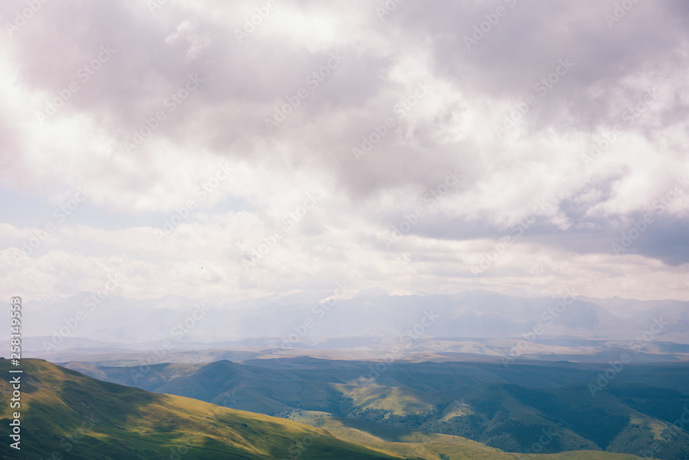 View from the Bermamyt Plateau on a summer day. Hills and clouds in the distance.