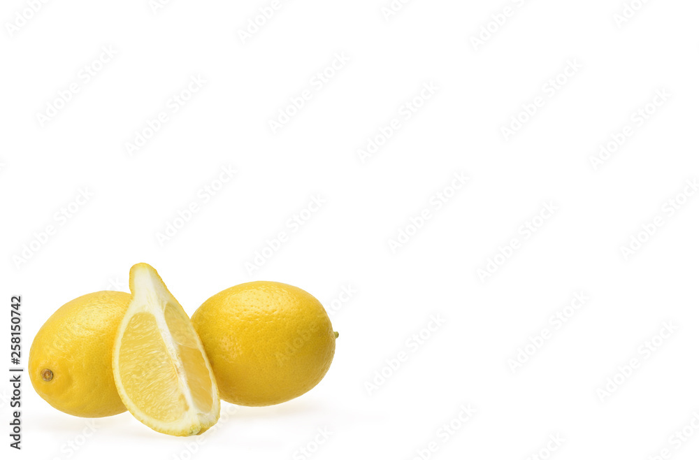 The composition of two bright lemons and halves on a neutral white background The composition of two bright lemons and halves on a neutral white background