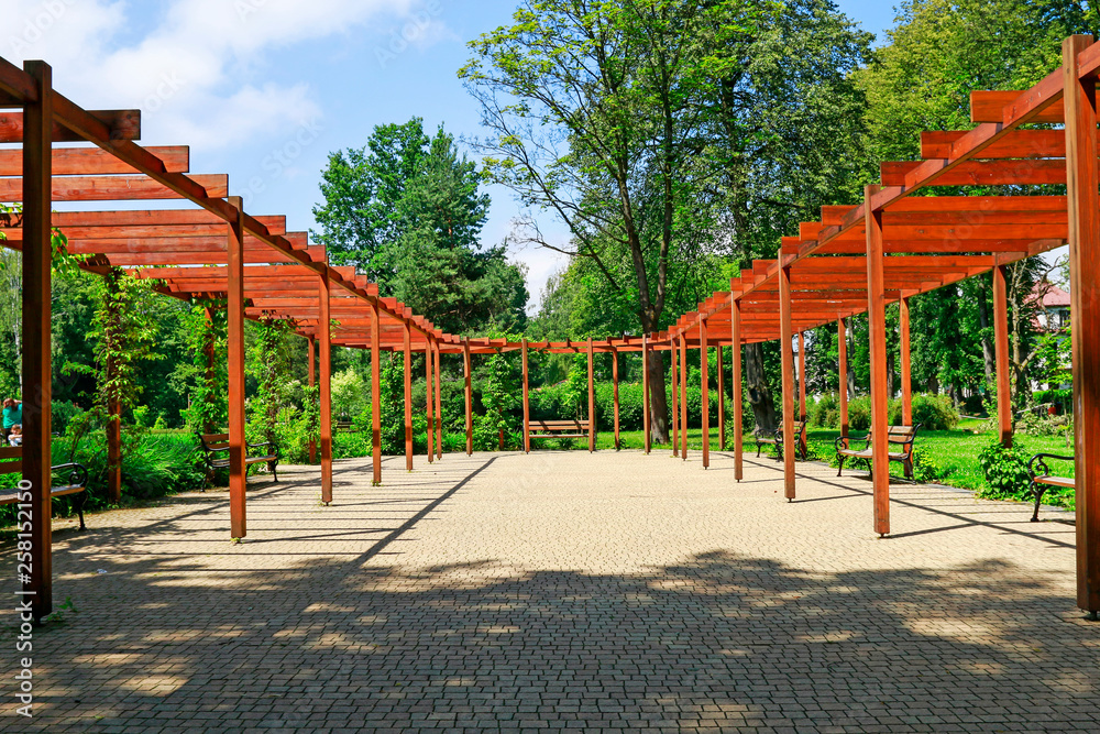 RABKA ZDROJ - JUNE 12, 2017: Wooden pergola roof in beautiful city park RABKA ZDROJ - JUNE 12, 2017: Wooden pergola roof in beautiful city park