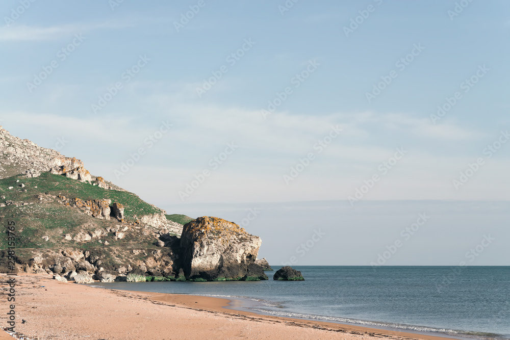 rocky coast of the sea bordering a sandy beach