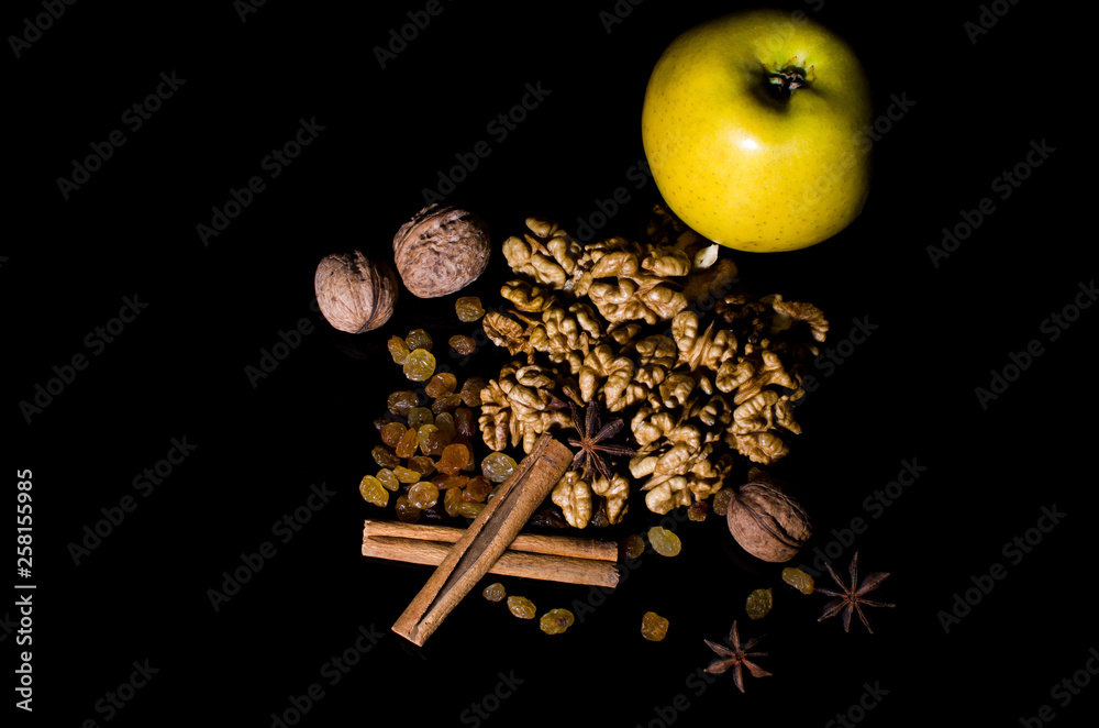 nuts and raisins on a black background nuts and raisins on a black background