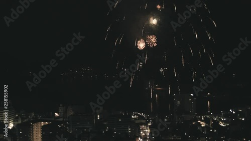 IZU atami, Japan skyline at night with fireworks exploding across the night sky. photo