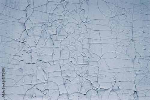 Light blue background of old cracked paint. Pattern of cracked blue paint texture wall background. Blank space. Grey grunge textured wall abstract background.