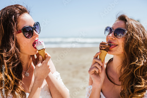 Lesbian couple walks in summer and they eat ice cream