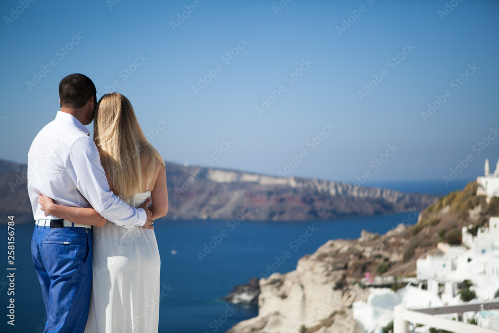young couple pregnant on the most romantic island Santorini, Greece