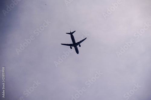 A passenger plane flew in a cloudy, gloomy sky