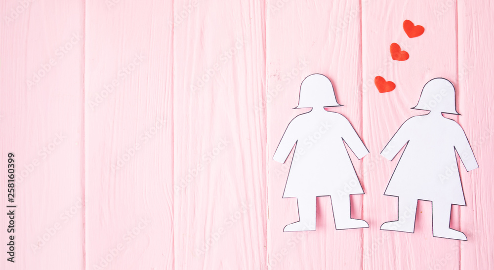 Lesbian Couple Together Concept . Two paper woman on pink background. Lesbian Couple Together Concept . Two paper woman on pink background.
