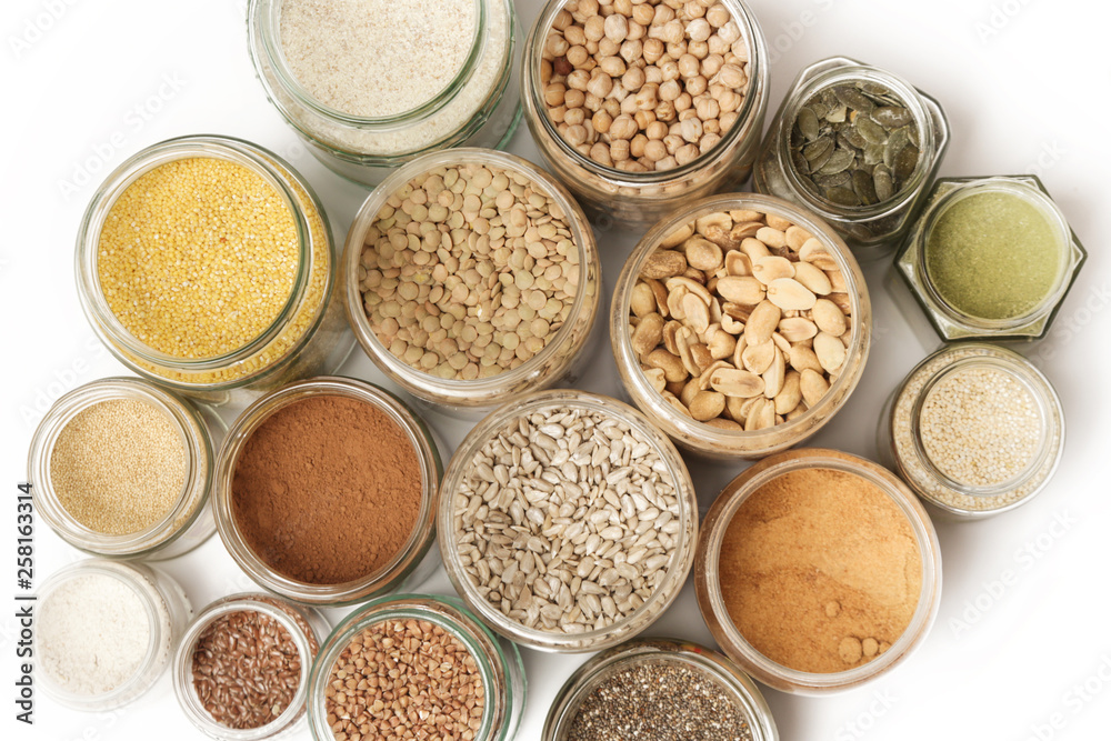 Top view of jars with grains, seeds, legumes, flours and various food ingredients. Healthy food concept. Top view of jars with grains, seeds, legumes, flours and various food ingredients. Healthy food concept.